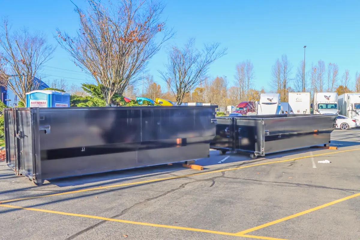 Professional dumpster rental service with roll-off container on residential driveway in Scotch Plains